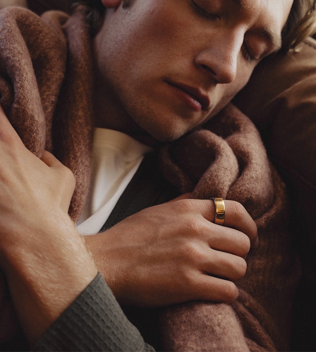 A person resting at home while wearing Auro Ring 5