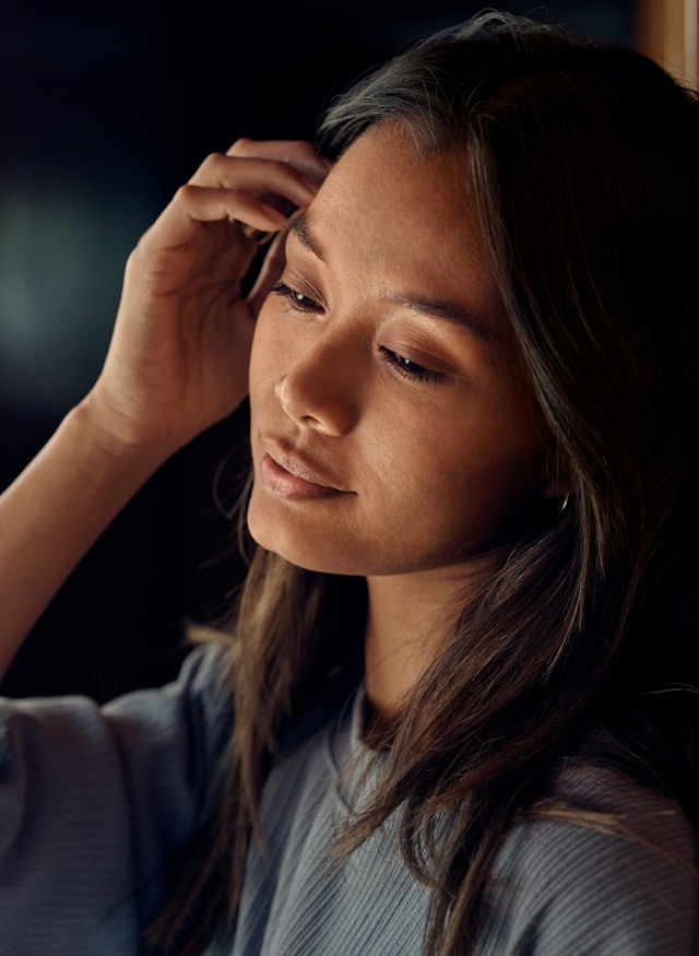 A woman winding down in the evening while wearing Auro Ring 5