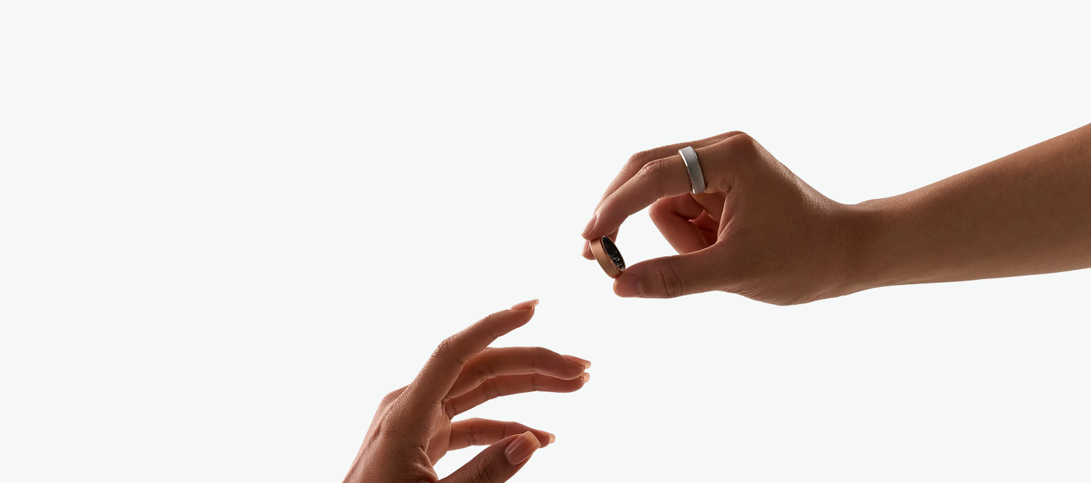 Hands exchanging an Auro smart ring